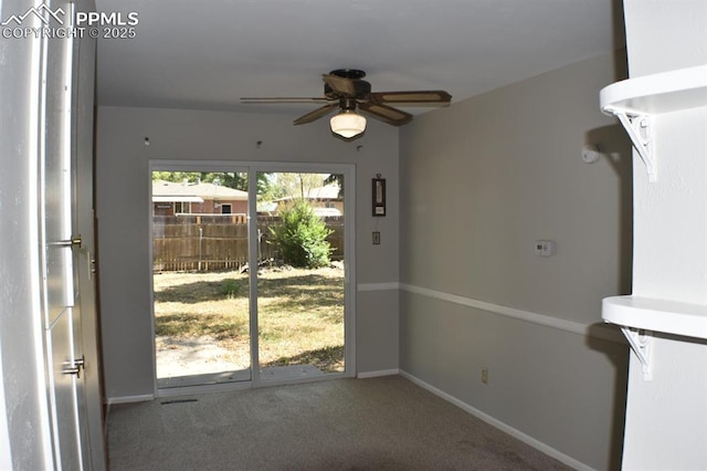 doorway with carpet flooring and ceiling fan