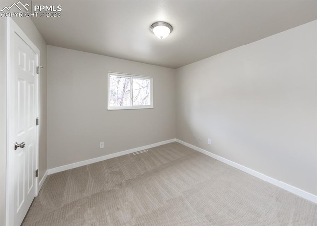 unfurnished room featuring light carpet