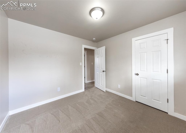 unfurnished bedroom featuring light colored carpet