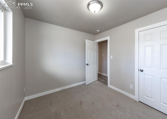 unfurnished bedroom featuring light colored carpet