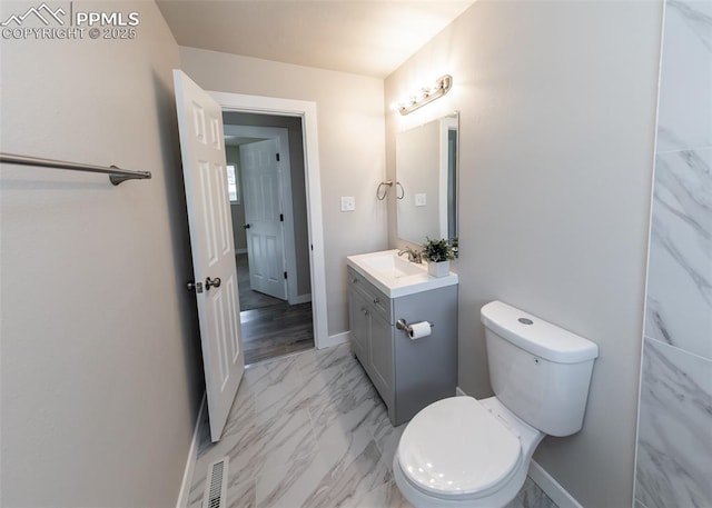 bathroom featuring vanity and toilet