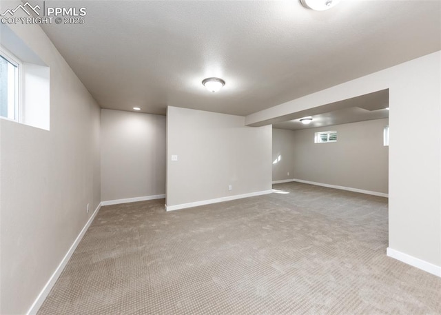 basement featuring carpet and plenty of natural light