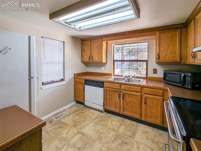 kitchen featuring white appliances and sink