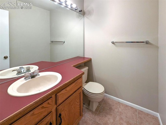 bathroom featuring tile patterned flooring, vanity, and toilet