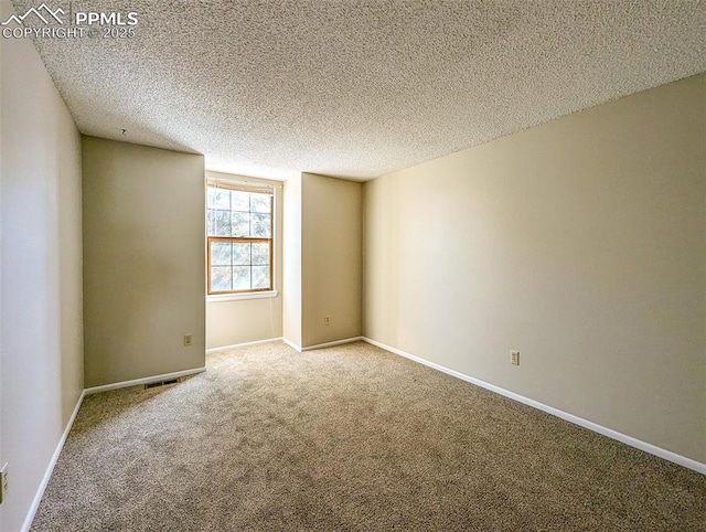 unfurnished room with carpet floors and a textured ceiling