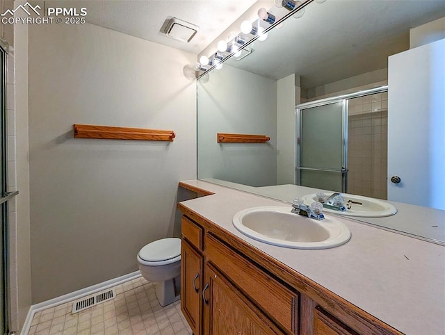 bathroom featuring vanity, toilet, and walk in shower