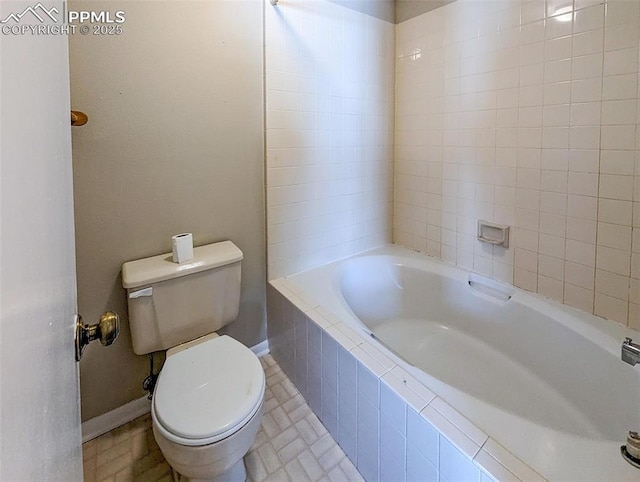 bathroom with tile patterned floors, tiled shower / bath combo, and toilet