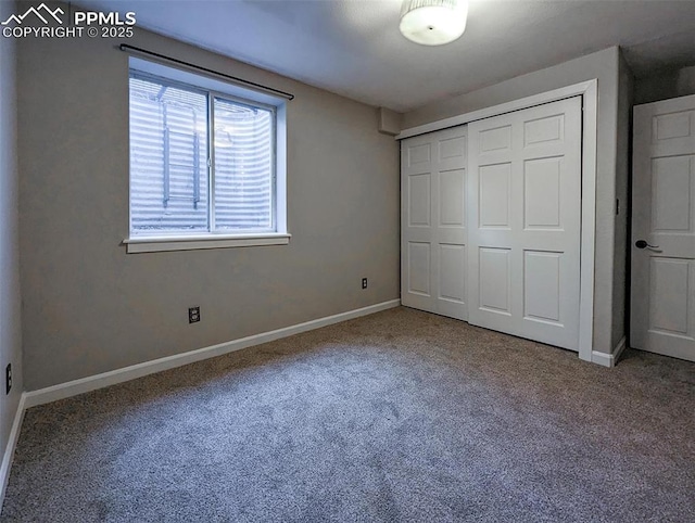 unfurnished bedroom with carpet flooring and a closet