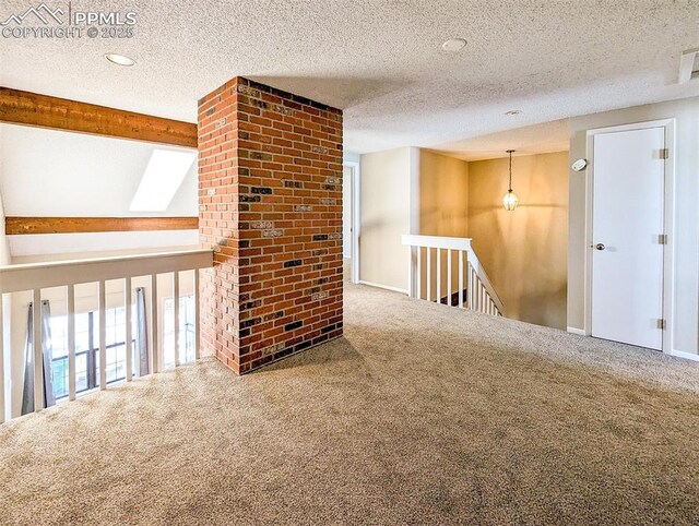 empty room featuring carpet floors and a textured ceiling