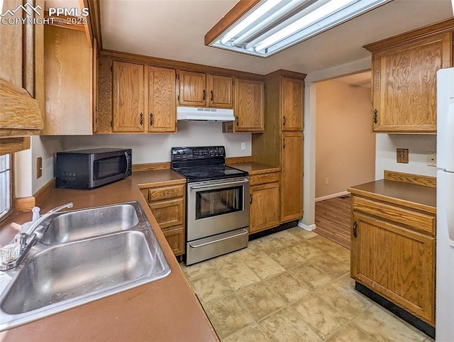 kitchen featuring stainless steel electric stove and sink