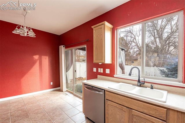 kitchen featuring sink, decorative light fixtures, stainless steel dishwasher, light tile patterned floors, and a notable chandelier