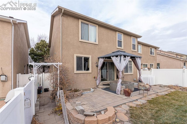 back of house featuring a gazebo and a patio area