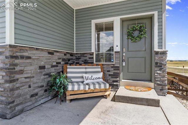 view of exterior entry with a porch