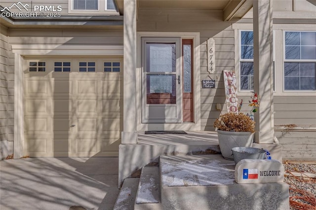 doorway to property with a garage