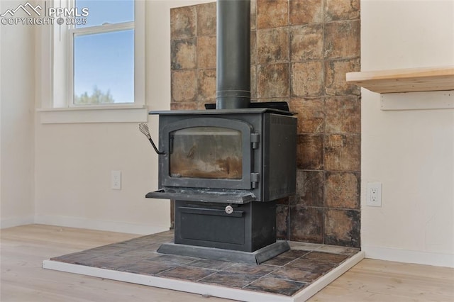 interior details featuring wood-type flooring and a wood stove