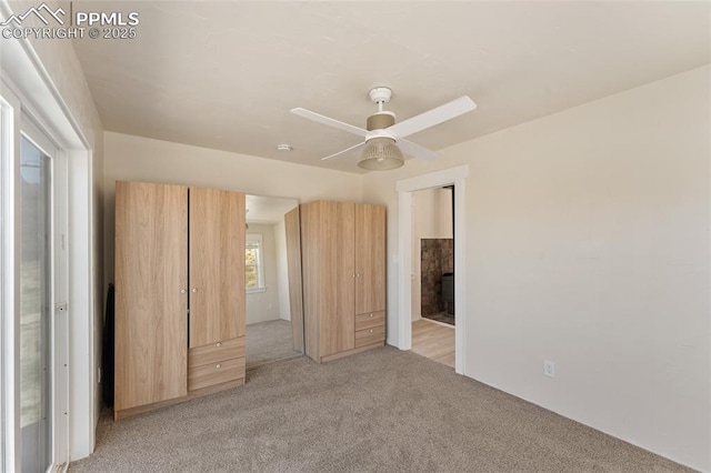 unfurnished bedroom featuring ceiling fan and light carpet