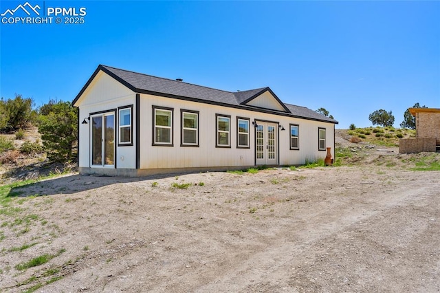 rear view of house featuring french doors