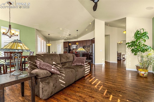 living room featuring high vaulted ceiling, a chandelier, and dark hardwood / wood-style flooring