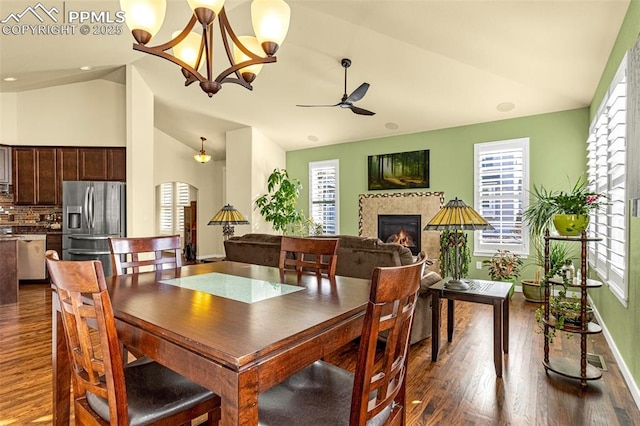 dining area featuring plenty of natural light, high vaulted ceiling, dark hardwood / wood-style floors, and ceiling fan