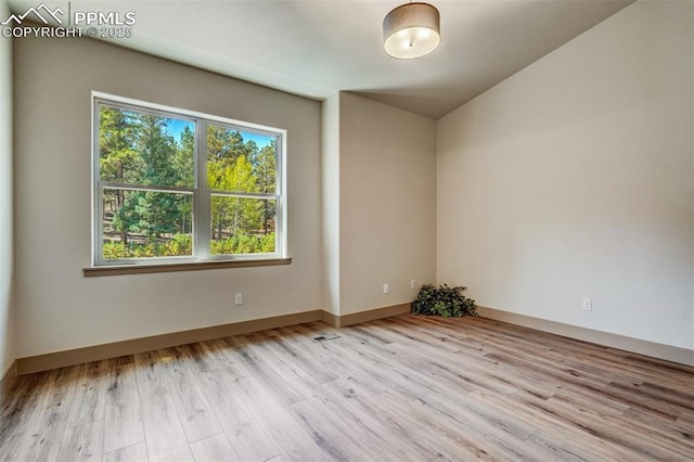 unfurnished room with light hardwood / wood-style flooring