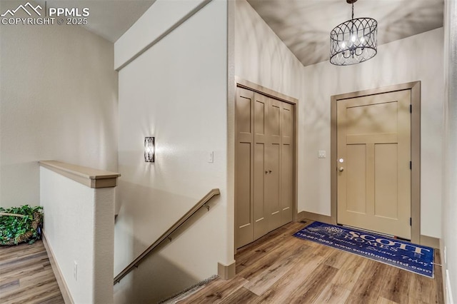 foyer featuring light hardwood / wood-style flooring and a notable chandelier