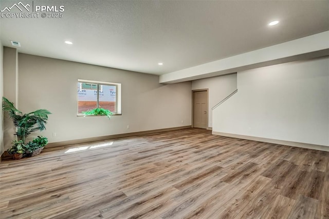 basement featuring light hardwood / wood-style floors