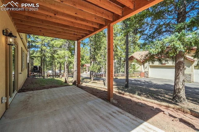 view of patio featuring a garage