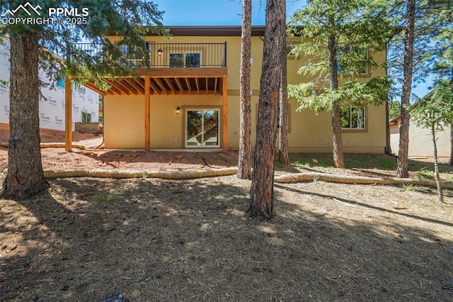 back of property featuring a balcony