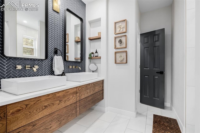 bathroom featuring tile patterned flooring, decorative backsplash, and vanity