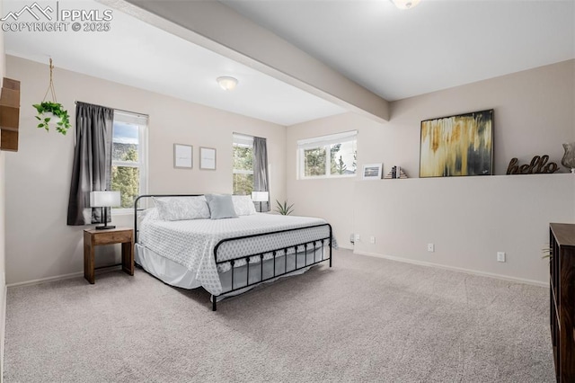 bedroom with beamed ceiling and light colored carpet