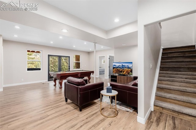 living room with french doors, light wood-type flooring, and pool table