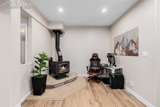 interior space featuring hardwood / wood-style flooring and a wood stove