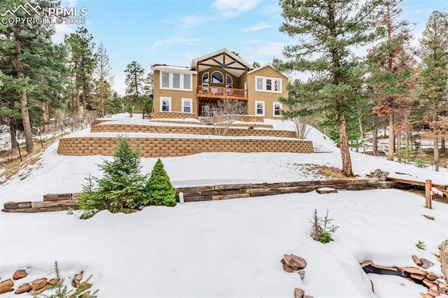 snow covered house with a balcony