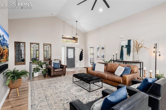 living room featuring ceiling fan, high vaulted ceiling, and light hardwood / wood-style floors