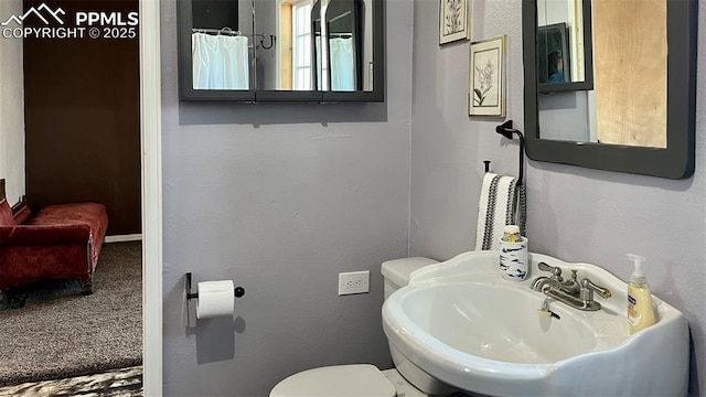 bathroom featuring sink and toilet