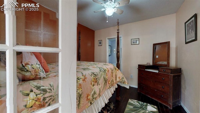 bedroom with a textured ceiling, ceiling fan, and dark wood-type flooring