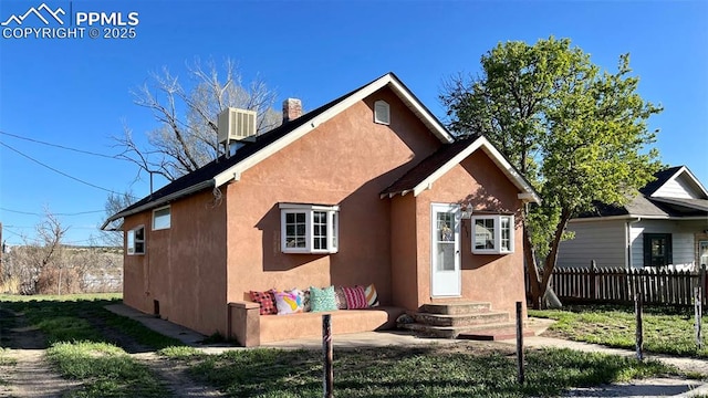 rear view of house featuring central AC