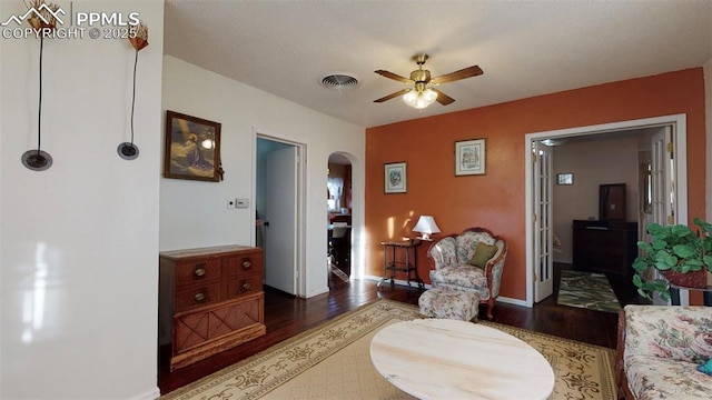 sitting room featuring dark hardwood / wood-style flooring and ceiling fan