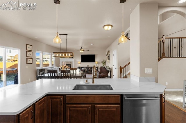 kitchen with stainless steel dishwasher, ceiling fan, sink, and decorative light fixtures