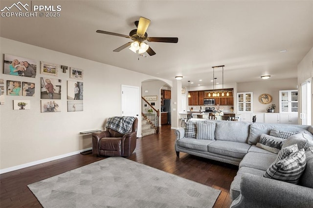 living room with dark hardwood / wood-style floors and ceiling fan