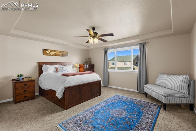 bedroom featuring a tray ceiling, ceiling fan, and light colored carpet