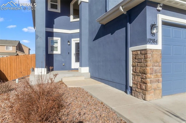 view of exterior entry with a garage