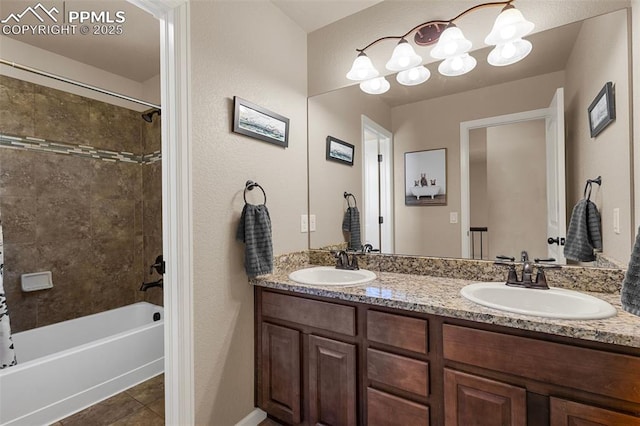 bathroom featuring tile patterned flooring, shower / tub combo, and vanity