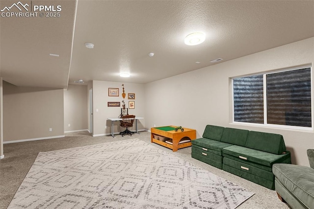 carpeted living room featuring a textured ceiling