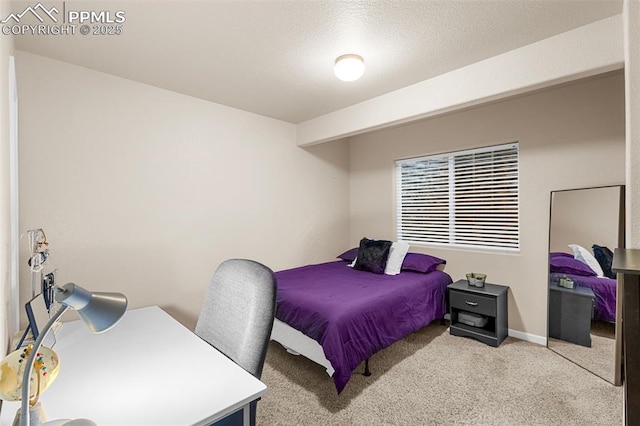 carpeted bedroom featuring a textured ceiling