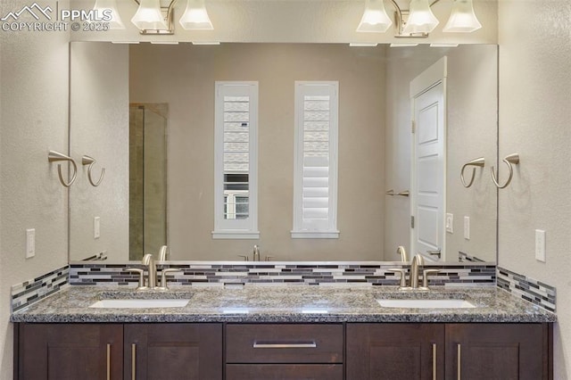 bathroom with vanity, a shower with door, and tasteful backsplash