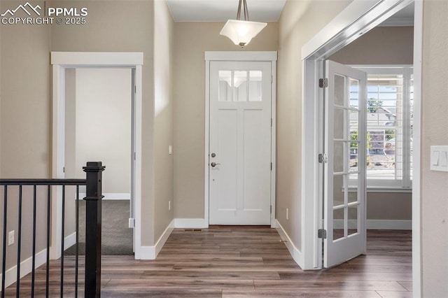 entrance foyer with dark hardwood / wood-style floors