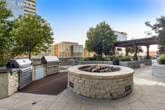 view of patio / terrace featuring exterior kitchen, a grill, and a pergola