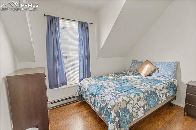 bedroom featuring dark wood-type flooring and a baseboard heating unit