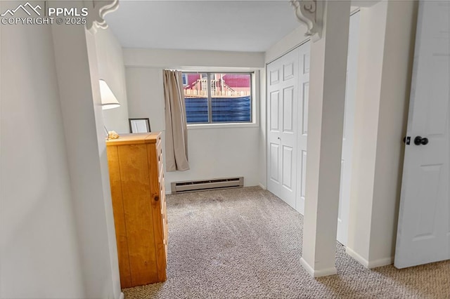 hallway featuring carpet and a baseboard radiator